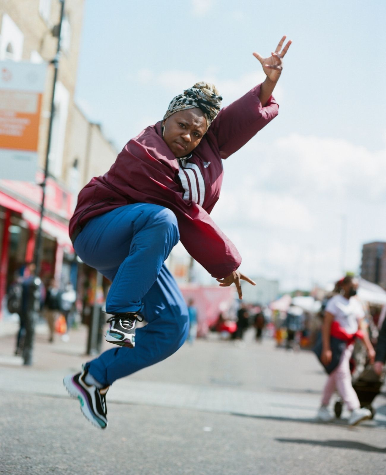 Female hip hop dancer leaps in the air on the streets of London