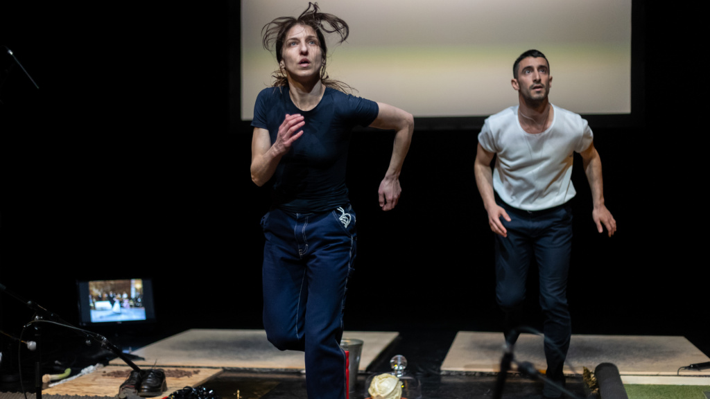 Greek artist Ioanna Paraskevopoulou runs on stage in her performance of MOS